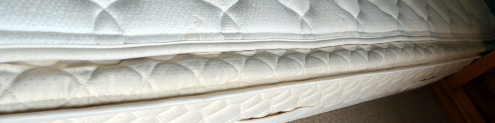 Close-up of mattress with pillow top removed.